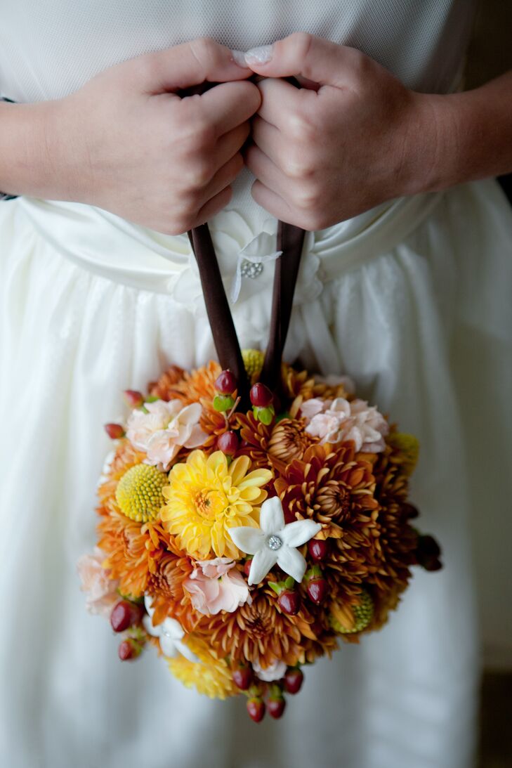 Sara and Rob's three flower girls carried fall-colored pomanders of orange dahlias, stephanotis, craspedia and red hypericum berries.