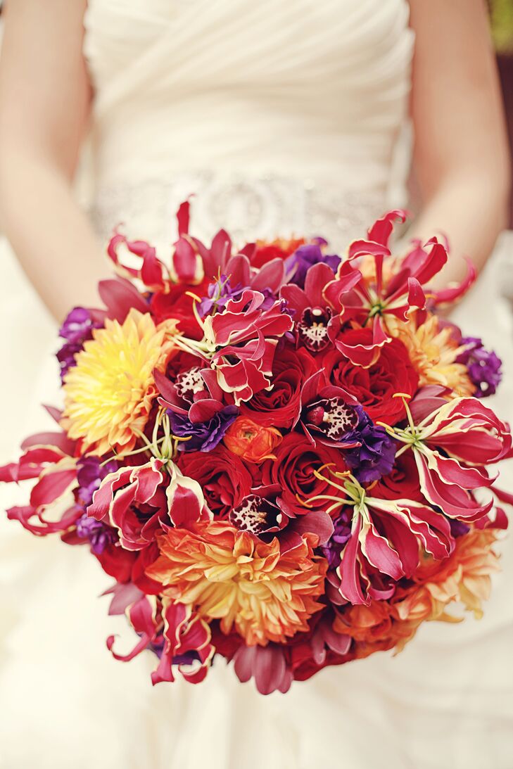 The bridal bouquet was made up of red gloriosa lilies, roses and orchids accented with orange dahlias, creating a colorful bouquet to go along with the Old Spanish theme.