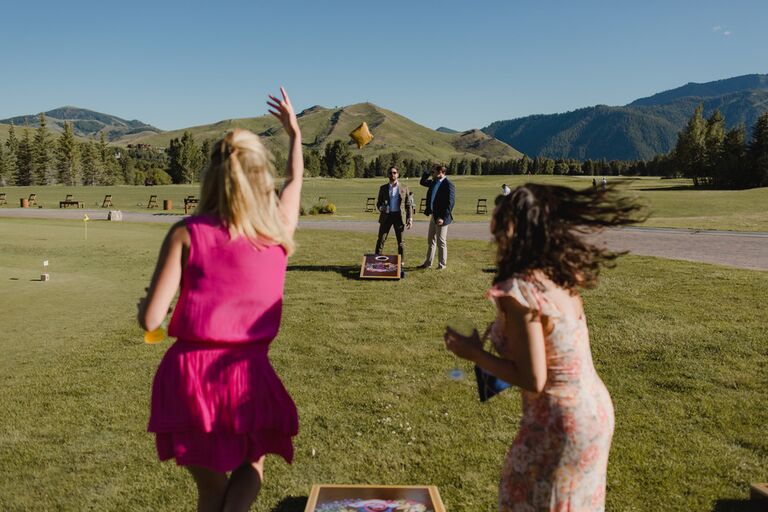 Wedding guests playing corn hole