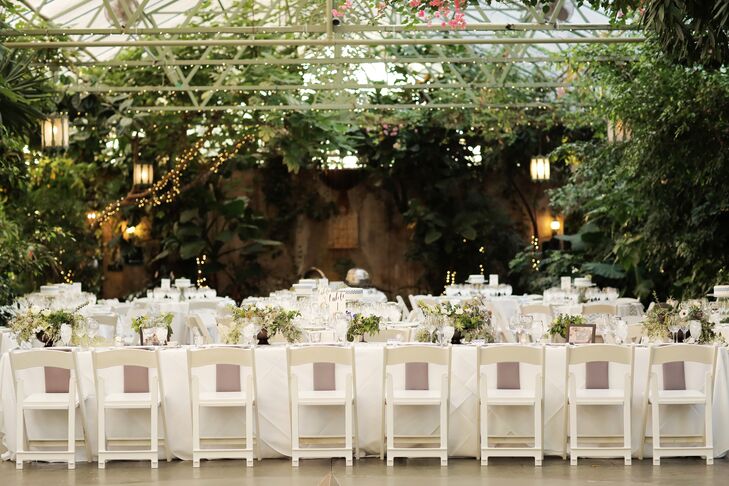 Tables inside the greenhouse (some round, some banquet-style)  were set with fresh white tablecloths and topped with succulents and individual cakes from Salt City Bakery in Utah.