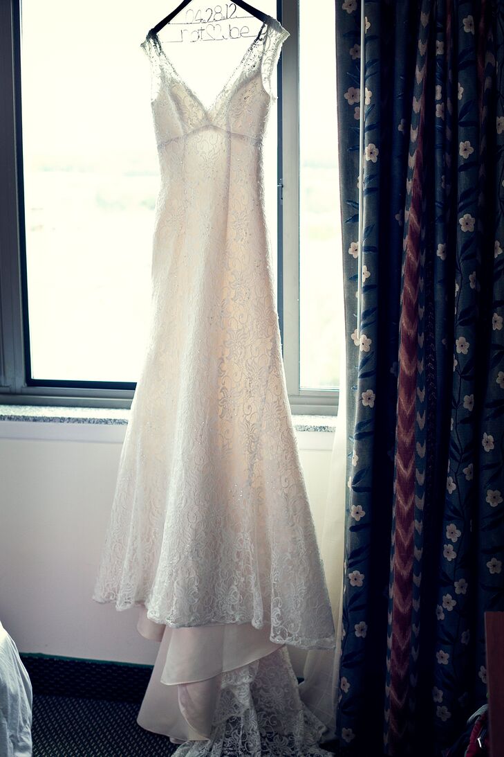 Natalie wore a lace sheath wedding dress with a V neckline and V back, which she bought from David's Bridal.