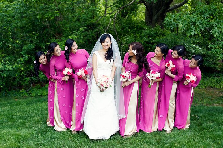 The bridesmaids wore fuschia ao dai, which are traditional Vietnamese outfits. They wore their hair side swept with flowers and carried bouquets of blush and fuschia roses and lilies.