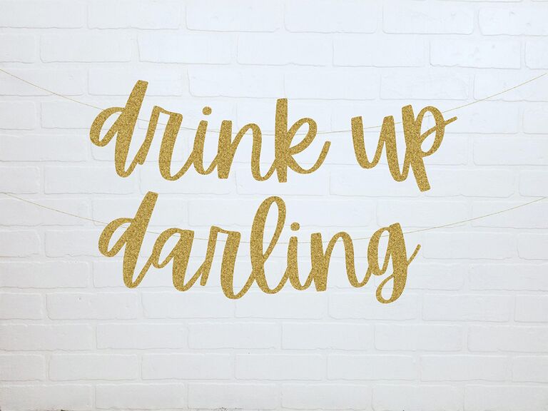 'drink up darling' banner in sparkly gold type