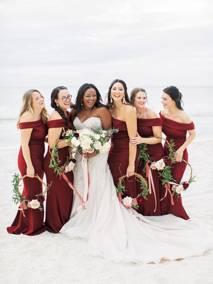 Bride and Bridesmaids in Burgundy Gowns Carrying Wreaths