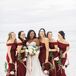 Bride and Bridesmaids in Burgundy Gowns Carrying Wreaths