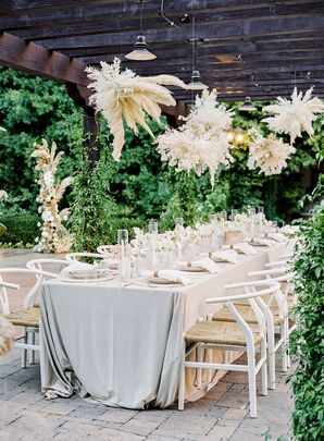 Boho Reception Table With Pampas Grass Chandeliers and White Wishbone Chairs