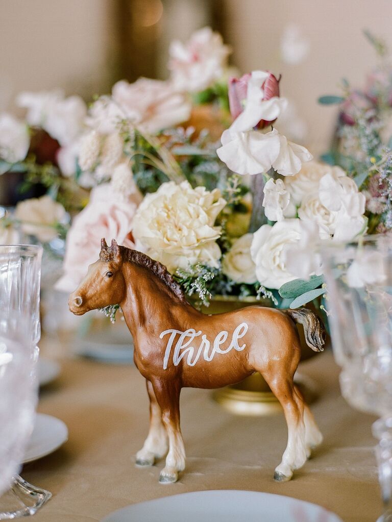 Cute horse figurine on a dining table with a number written on its side. 