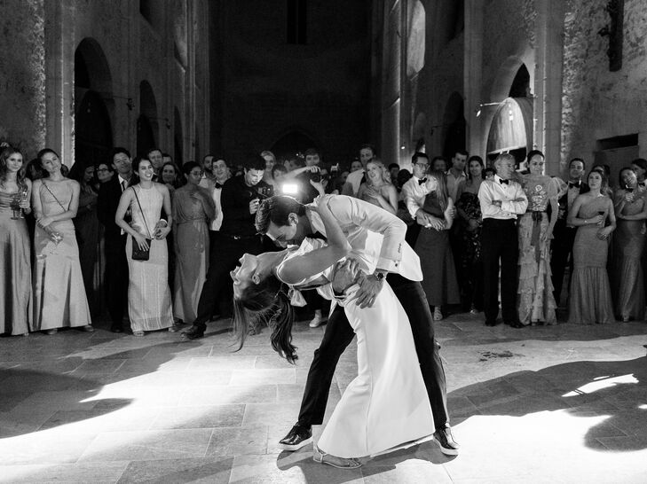 Black-and-White Photo of Groom Dipping Bride on Dance Floor at Historic French Venue