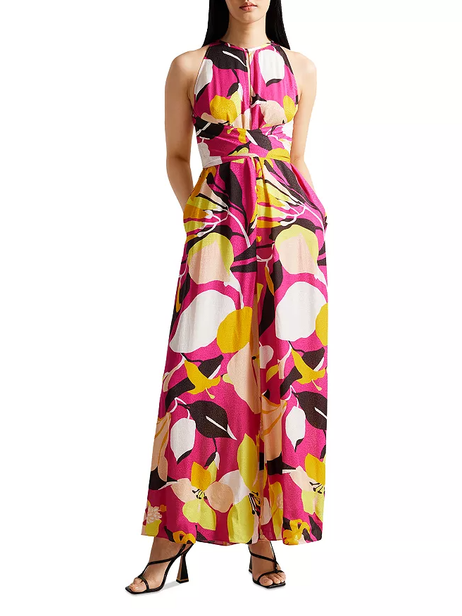 Model wearing high-neck jumpsuit in pink with abstract details