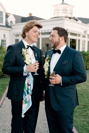 Couple Wearing Tuxedos With Floral Lapel Accents
