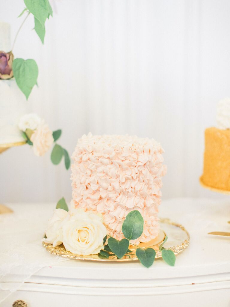 one tier wedding cake with light pink ruffled buttercream icing