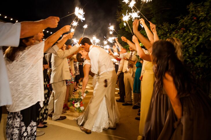 Joshua dipped Sarah for a quick kiss and wedding guests created  a tunnel around the newlyweds for their grand exit.