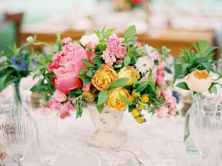 Pink and yellow wedding reception centerpiece with garden roses and dahlias