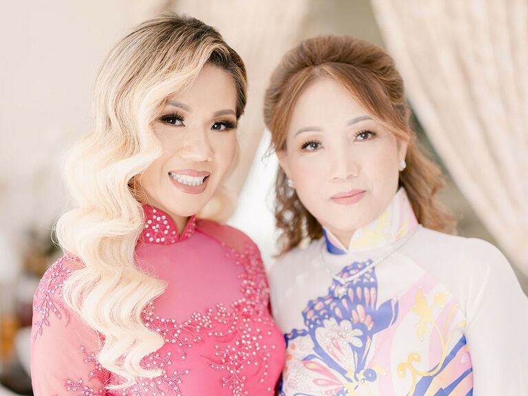 Mother of the bride wears her hair in a sleek half-updo. 