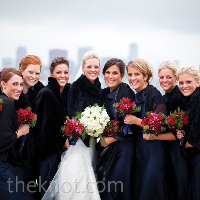 Katie’s bridesmaids wore formal navy floor-length gowns topped off with black shawls or faux-fur jackets.