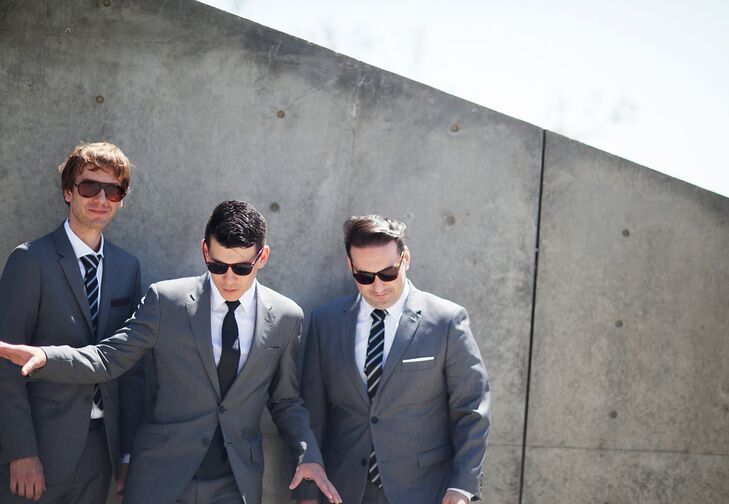 Like Danielle, David took his wedding day look in a more modern direction, selecting a sleek gray suit by Topman and black tie for his walk down the aisle. His two groomsmen donned similar styles, which they accessorized with white pocket squares and striped ties.