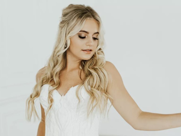 bride with curled half up half down hair and brown smokey eye