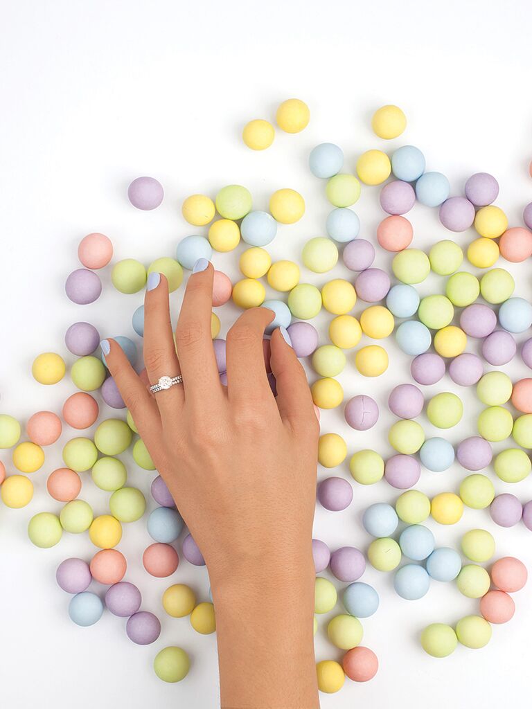 Engagement ring selfie idea with a fun candy background