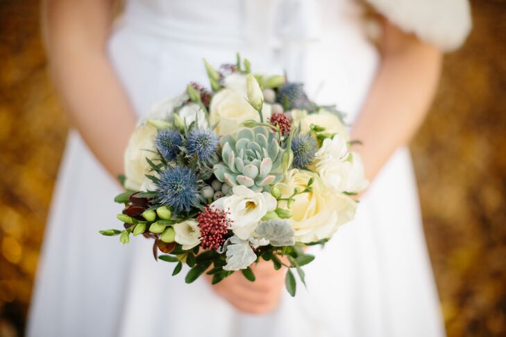 Louise carried a unique bridal bouquet made up of succulents, thistles and holly along with ivory roses and dusty miller for her fall wedding.