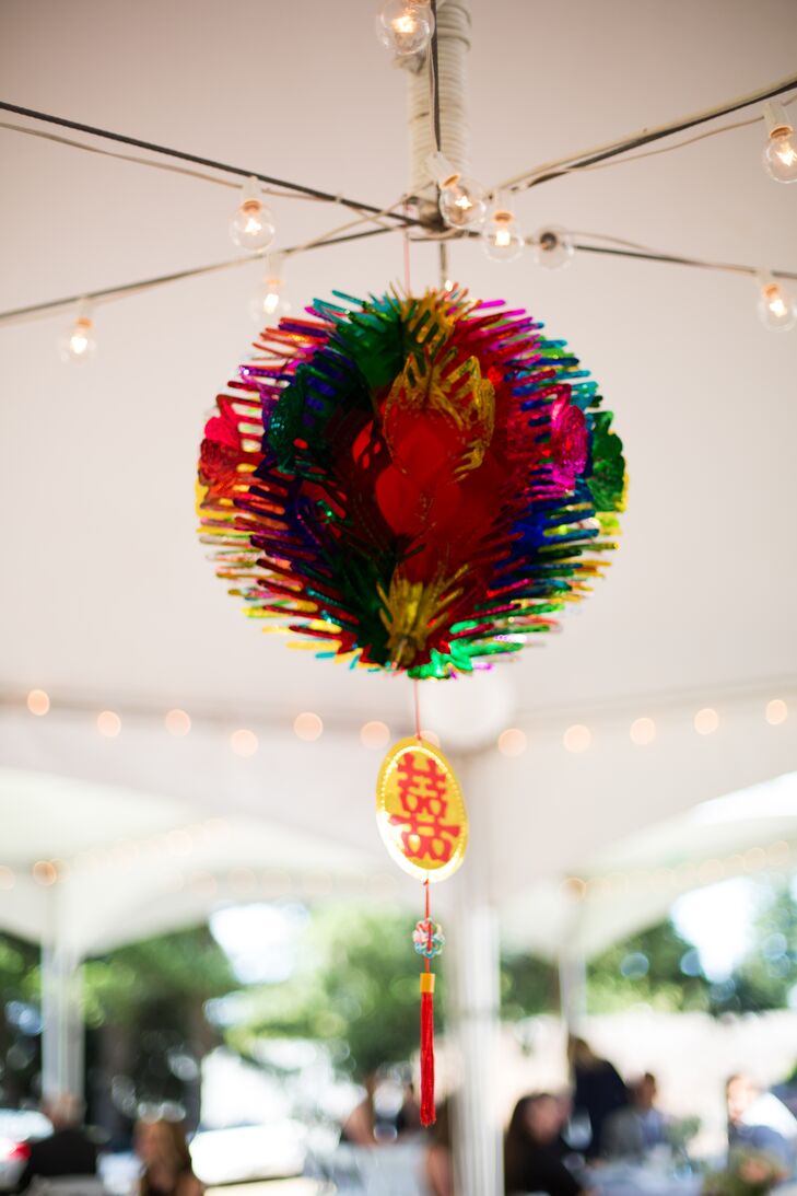 A colorful lantern hung from the ceiling of the white tented reception, reflecting Denise's family background among many other wedding day details.