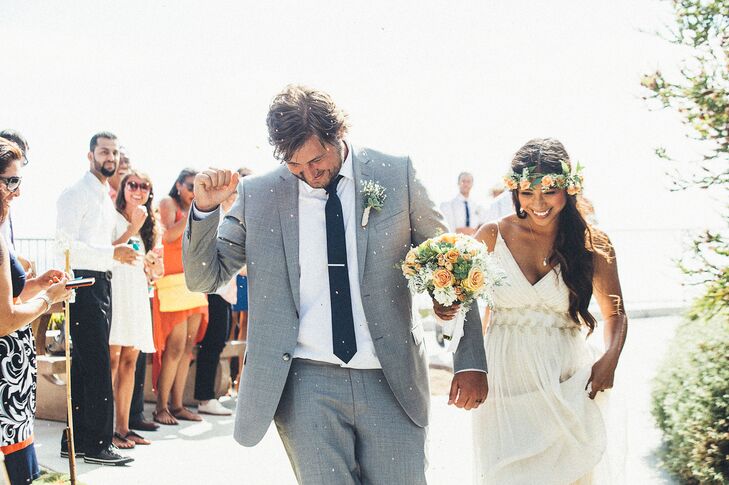Dewi wore an ivory wedding dress with a V-neck and a gold leaf design accenting the waistline.