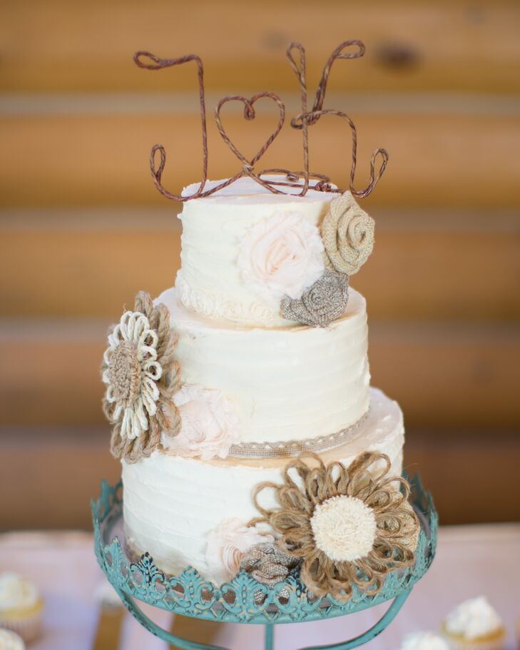 Two Sisters Bakery create this three-tier confection topped with rustic-inspired twine flowers.