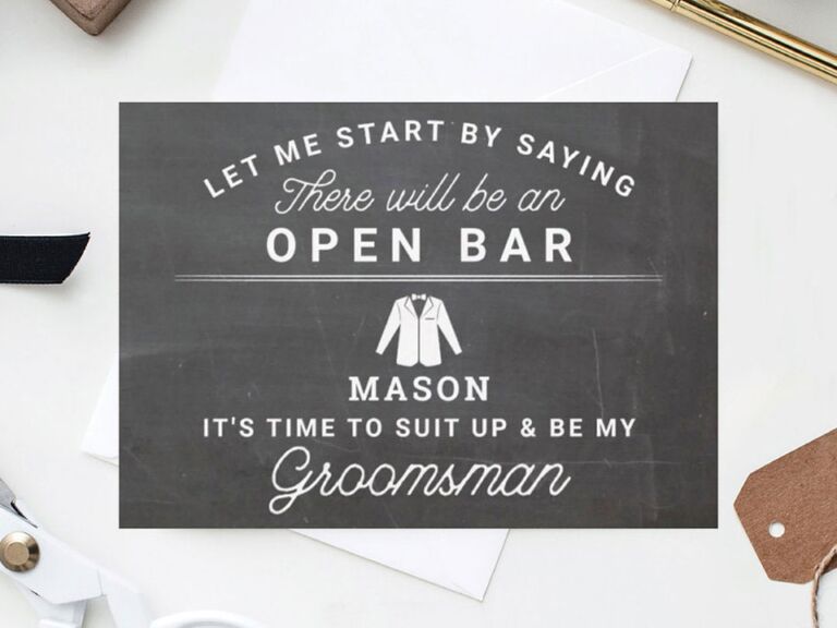 Black chalkboard background with Let Me Start By Saying There Will Be An Open Bar in white type groomsman card
