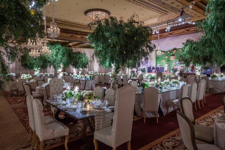 I loved how the romantic theme was played out in the space with four weeping willow trees that were punctuated by flowers that climbed up the trunks of the trees, describes Leslie. Crystal chandeliers were brought in and placed above the dance floor to draw the eye into the center, really enhancing the intimate and romantic feel of the room.