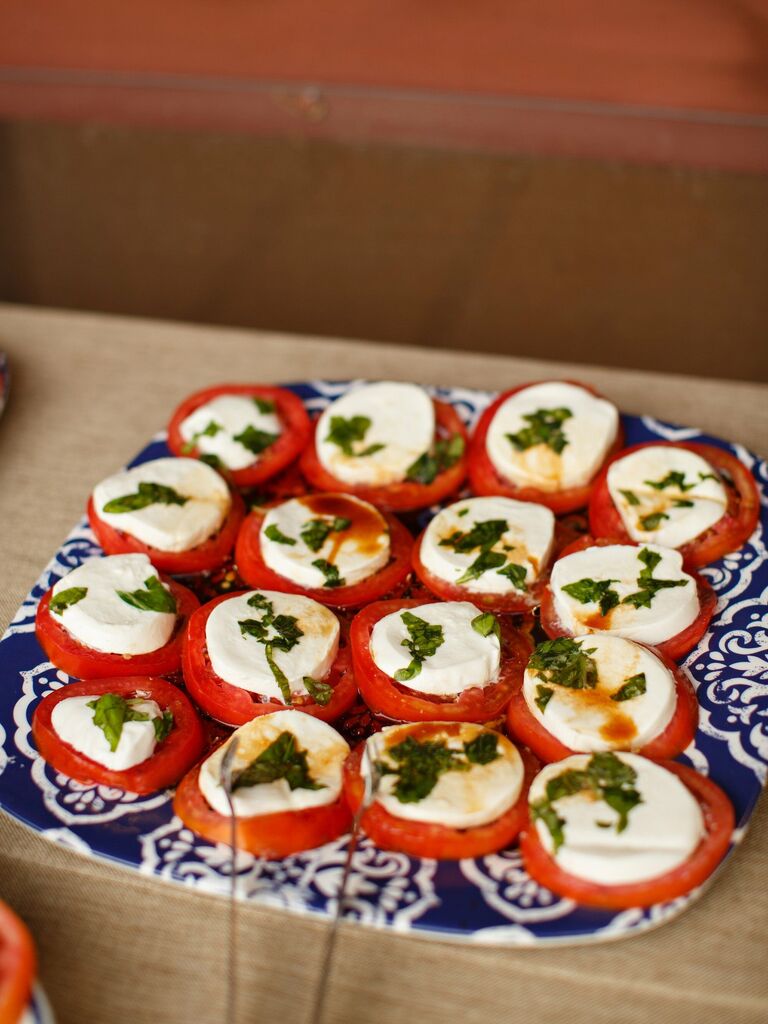 caprese salad wedding appetizer served on patterned blue plate