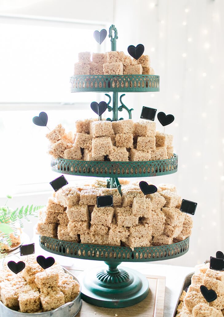 The groom’s cake was a tiered display of Rice Krispies Treats -- the groom’s favorite. The couple added paper hearts and shapes to accent the teal dessert display.