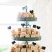 The groom’s cake was a tiered display of Rice Krispies Treats -- the groom’s favorite. The couple added paper hearts and shapes to accent the teal dessert display.
