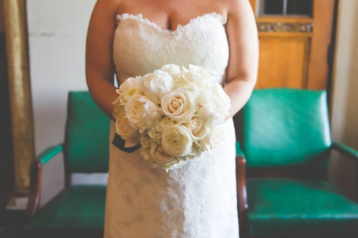 Wedding Flowers by Heidi created this lush ivory arrangement for the bride using a mix of roses and ranunculus.
