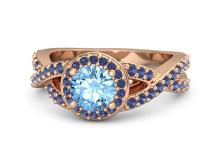 Round blue topaz center with sapphire halo and sapphire accents on twisted rose gold band 