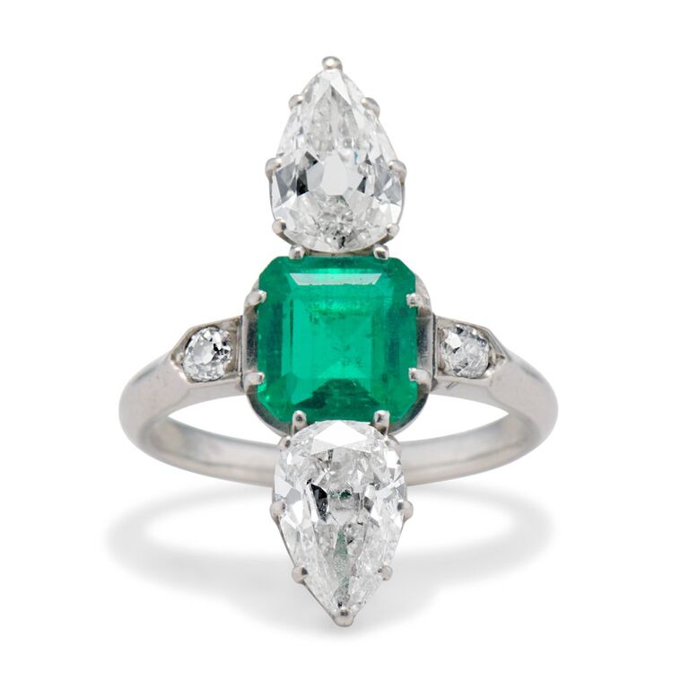 Emerald and diamond ring with a silver band by Erstwhile. 