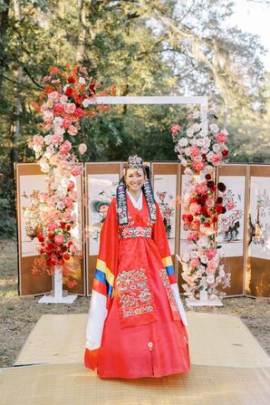 Bride in Traditional Korean Hanbok Gown at Paebaek Ceremony With Floral Arch