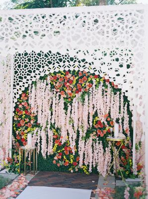 White Laser-Cut Chuppah Decorated With Floral Garlands and Poppies