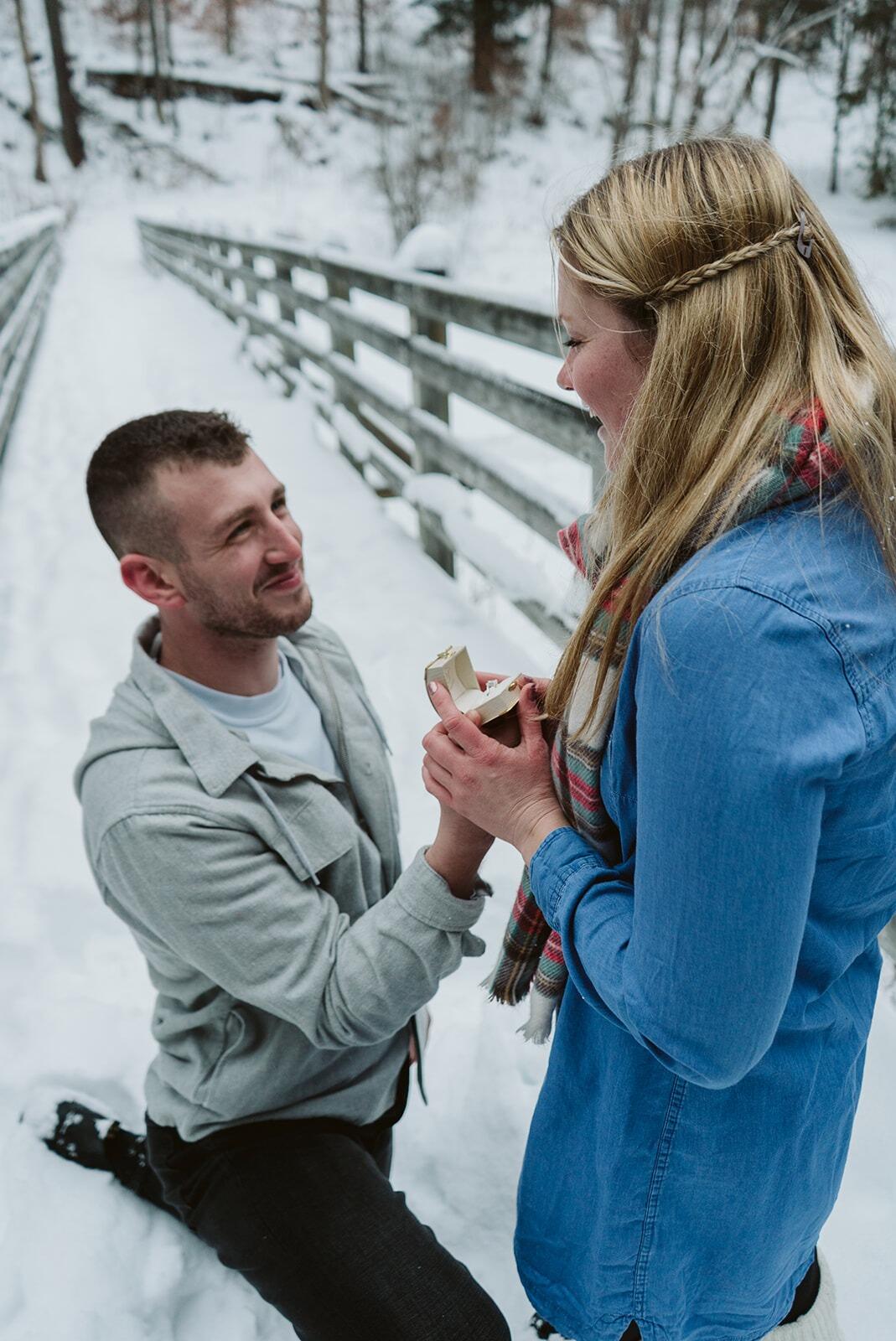 Colton and Bethany went to Marilla Bridges Trail in Bradford, PA to take Christmas Card photos. Little did Bethany know that there was a surprise planned. Near the end of the photo shoot, Colton got down on one knee and asked her to marry him!