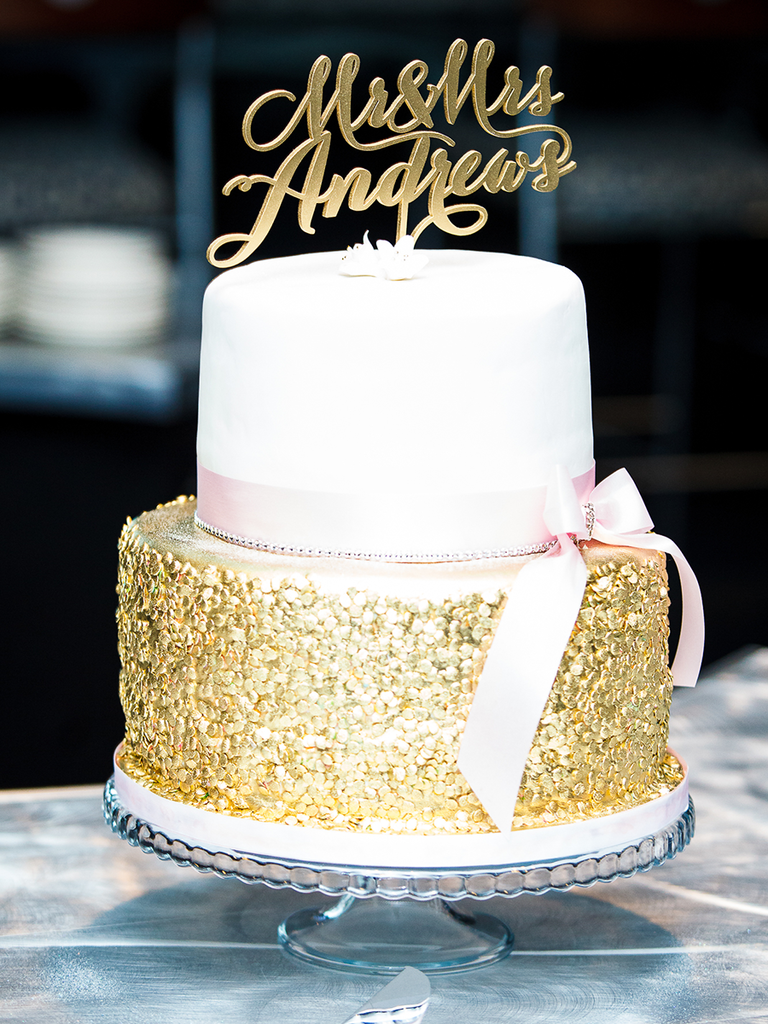 Simple two-tiered wedding cake with metallic gold detailing