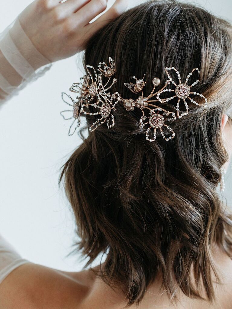 Model wears a floral headpiece with crystal embellishments. 