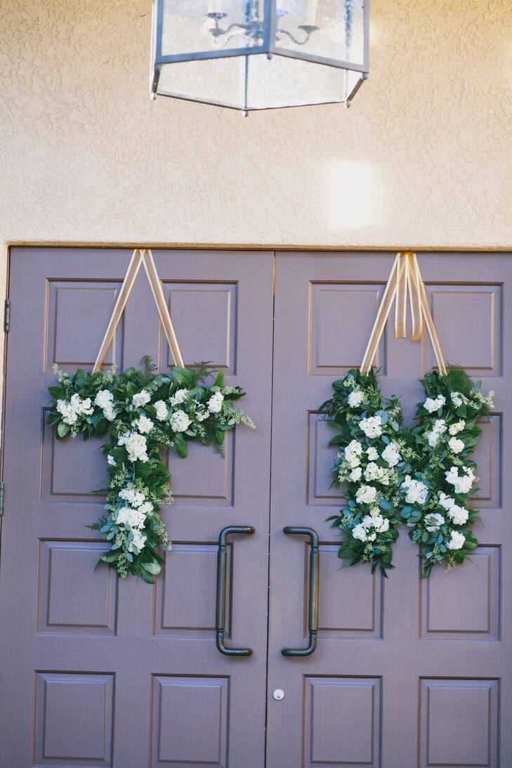 Elegant Details created lush hanging decorations made of green leaves speckled with ivory blooms. The arrangements spelled out "T" for Tyler and "N" for Nadia, which added a cute personal touch to the decorations.