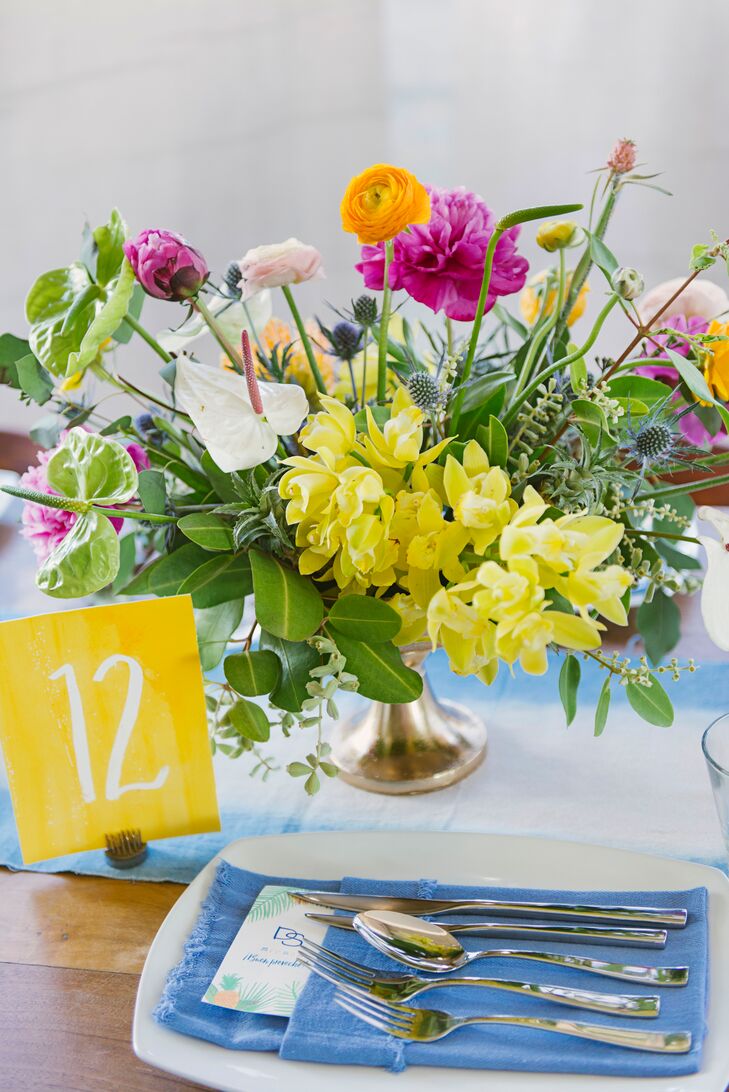 The day's tropical-inspired palette was reflected in bright yellow place cards, blue hand-dyed linens, dip-dyed tablecloths and napkins. "It all went along with the watercolor-based design used throughout our stationery and other paper goods," Diana says.
