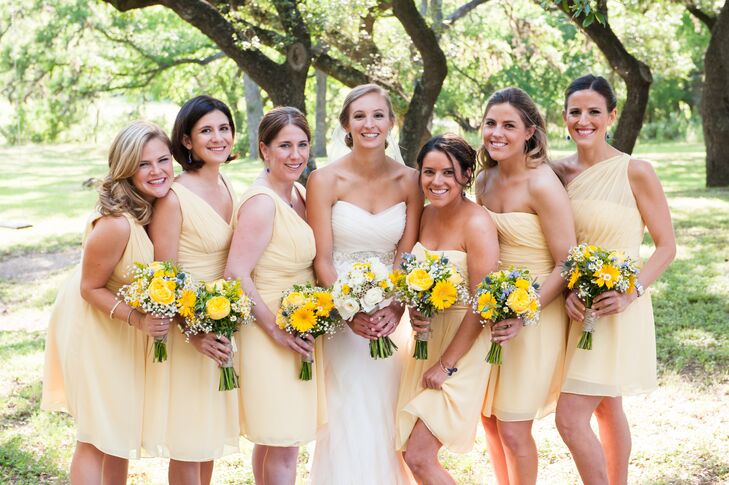 Sarah's bridesmaids wore short, canary yellow dresses in different styles for a light and comfortable look. Their bouquets, which included yellow daisies and baby's breath with touches of blues and greens, had a wildflower feel.