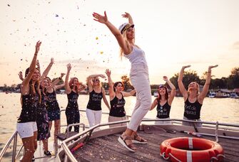 Bride and bridesmaids on a boat at bachelorette party