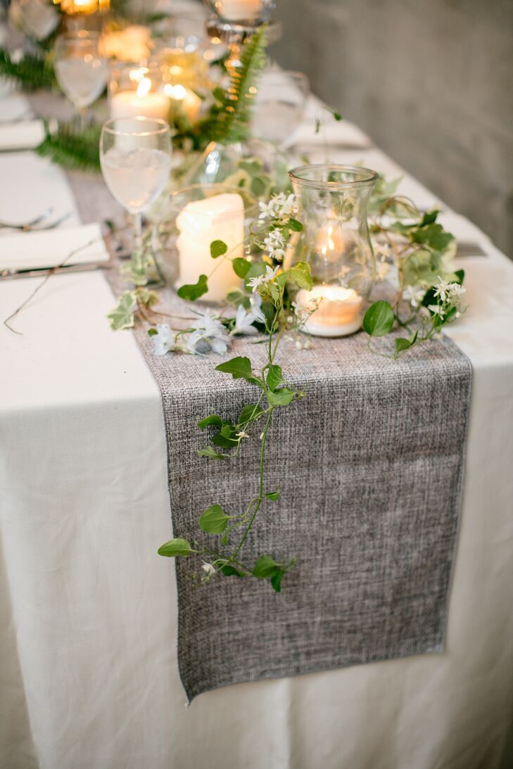 Rather than pinpoint a theme to guide their decor decisions, Samantha and Brian looked at creating a mood. “The inspiration was just about the feel—nothing flashing, nothing that would stand out,” Samantha says. The couple drew their palette from the venue’s industrial elements, cool concrete walls, natural wood floors and silvery exposed pipes and vents, infusing the room with shades of ivory, charcoal, blue and green.