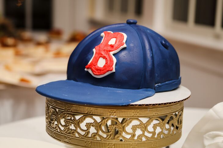 While their entire wedding was covered with soft shades of blush, ivory and gold, Lindsey and George went with something a little more bold for dessert. They picked out a groom's cake shaped like the Boston Red Socks' signature caps from LadyCakes.