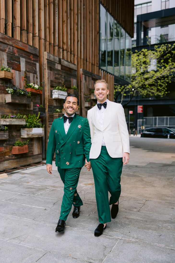 Groom in Emerald Tux With Gems and Groom in White Tux Jacket, Emerald Pants Hold Hands