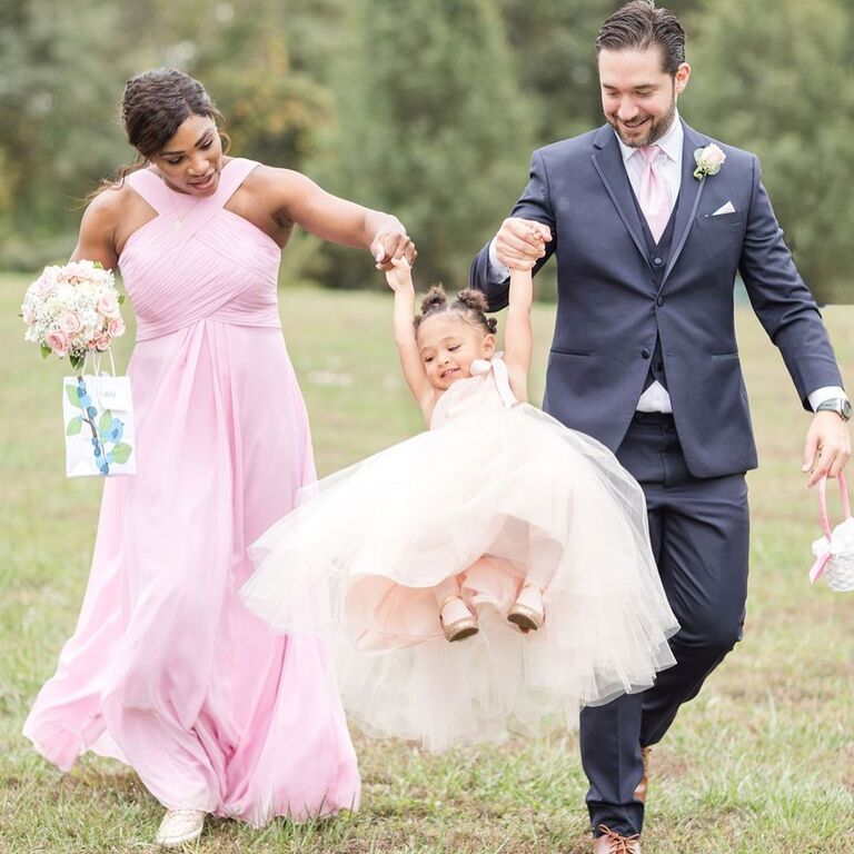 Serena Williams and partner walk with their daughter. 