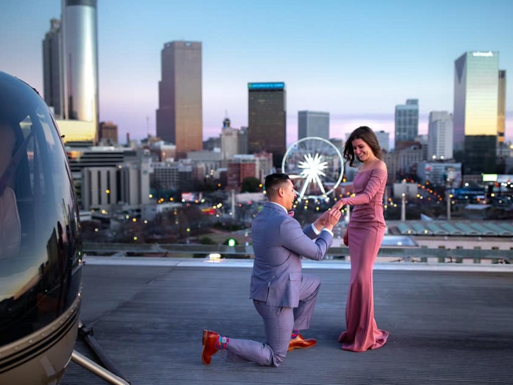 Man proposing to woman on rooftop Ventanas in Atlanta