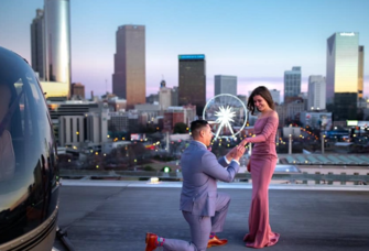 Man proposing to woman on rooftop Ventanas in Atlanta