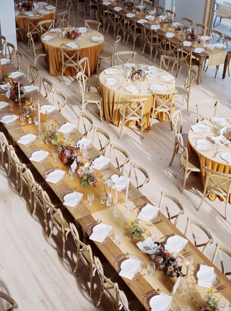 Long farm table with yellow runner and wood cross-back chairs